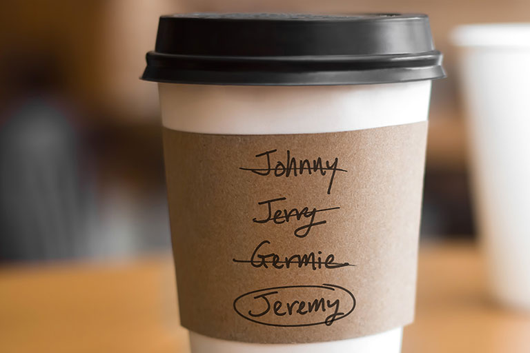 A coffee cup with several variations of Jeremy crossed out with the name Jeremy circled at the bottom.