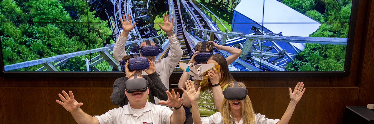 Photo of Learning Spaces team experiencing a virtual reality roller coaster