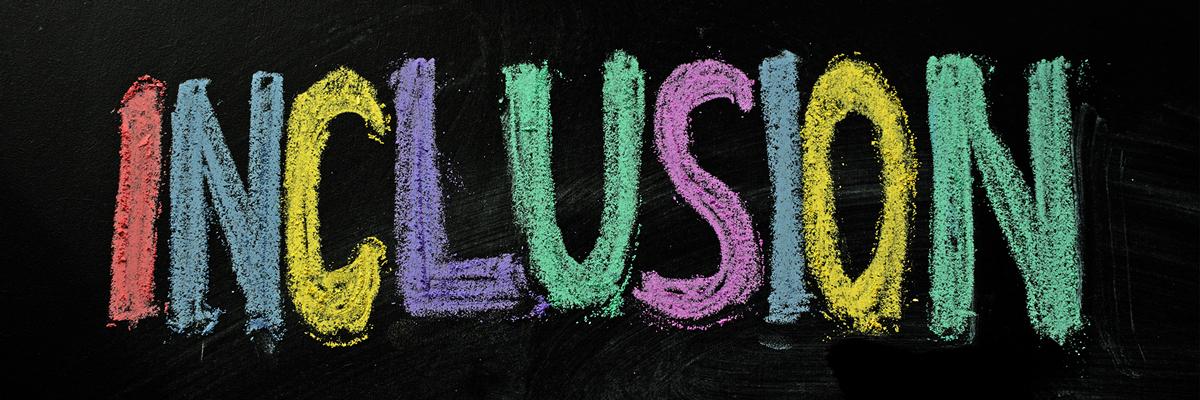 Inclusion written in multiple colors on a chalkboard