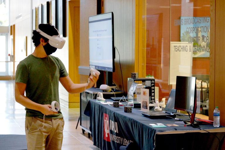 A college student wearing a VR headset