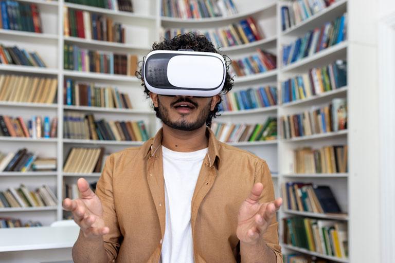 young man wearing a VR headset in a library