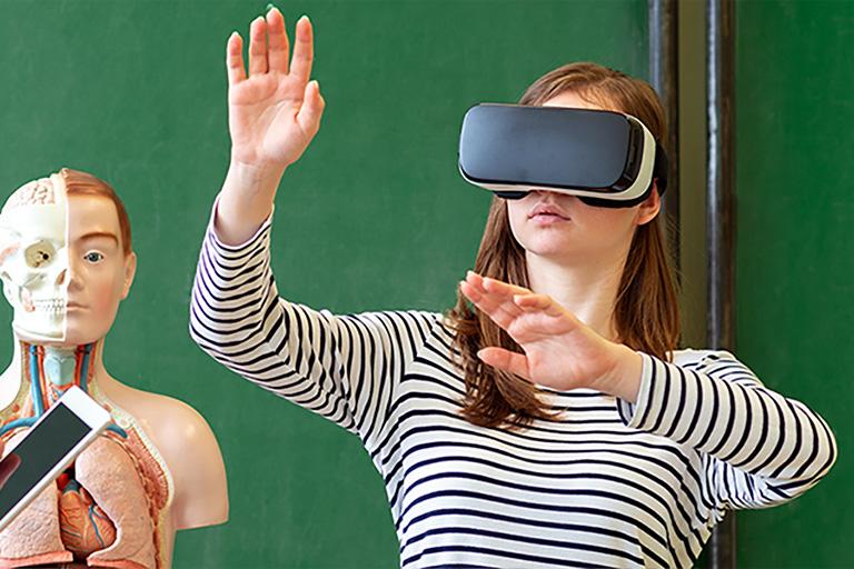 a 3D anatomy model and a student wearing a VR headset